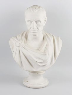 A large Victorian parianware bust of Julius Caesar, modelled in typical robes on spreading circular