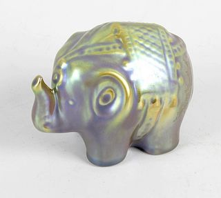A small Zsolnay Pecs Eosin lustre elephant. Modelled in standing pose with trunk raised, 3.75 long x