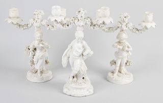 Three Continental porcelain twin branch candelabra, comprising a matching pair modelled as a young g