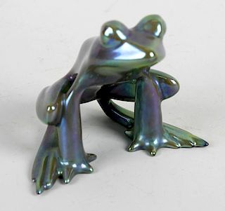 A small Zsolnay Pecs Eosin lustre pottery frog. Modelled seated upon his haunches, printed mark, 2.7