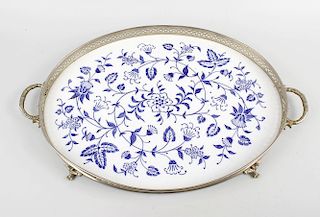 A twin handled ceramic mounted tray, the blue and white ceramic plaque of oval outline having foliat