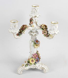 A Schierholz German porcelain candelabrum, having three scrolled branches leading to the central bal
