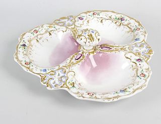A porcelain hors d'oeuvres dish, formed as three shallow and lobed dishes having central knob carry