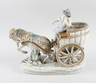 An Amphora porcelain figure group, modelled as a goat and cart formed as a basket with young boy, up