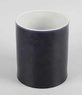 A Chinese porcelain brush pot, of cylindrical form with dark blue glaze, with six character mark to
