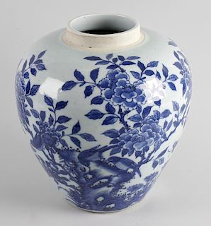 A Chinese porcelain vase of ovoid form, decorated with birds and flowers in dark underglaze blue upo