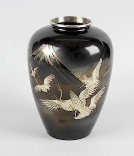 An early 20th century Japanese bronze vase. The ovoid form incised with view of cranes in flight bef
