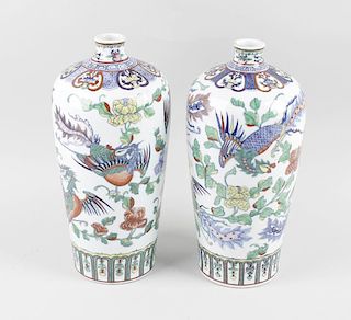 A pair of Chinese porcelain vases, of tall slight ovoid form decorated with phoenixes and foliage be