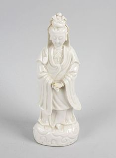 A 19th century Chinese blanc de chine figure, modelled as Guanyin stood in flowing robes upon a wave