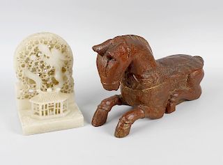 A Chinese painted and carved wooden model horse, of Archaistic type, in recumbent pose with gilt hig