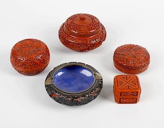 A group of cinnebar lacquer, comprising a box and cover, with pierced foliate design, another smalle
