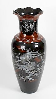 A floor-standing lacquered papier mache vase.Of ovoid form with wavy rim, the neck inlaid with panel