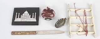 A group of oriental cabinet items, to include a carved Chinese ivory puzzle, a malachite blade handl