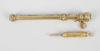 A gilt retractable pencil, the textured body with turquoise cabochons inset to terminal and raised b