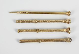 Four yellow metal propelling pencils, three having hexagonal body with foliate engraving, leading to