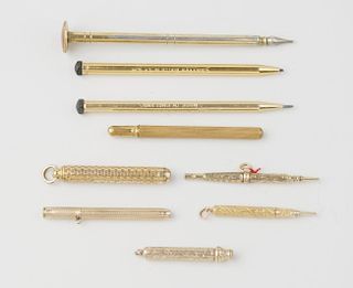 A small selection of gilt sleeved pencils, three with foliate engraving to barrels, one with 'cheque