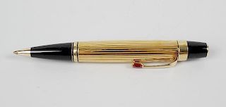 A Montblanc Boheme rouge ball point pen, the gold plated body with ribbed texture and ruby coloured