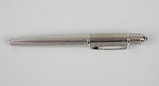 A Cartier rollerball pen, the engine turned decorated body with removable screw on cap, having overs
