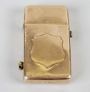A 9ct gold lighter, of plain rectangular form having raised shield decoration to front, marked 9ct t