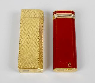 Two Cartier lighters, comprising a gold plated example with engine turned decoration to whole, plus