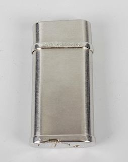 A Cartier gas cigarette lighter, the plain brushed steel body of oval rectangular hinged form, with