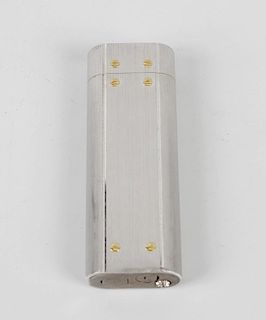 A boxed Must de Cartier silver-plated lighter. Of rounded oblong section with textured brushed finis