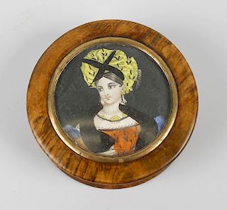 A 19th century burr maple snuff box, of circular form having inset portrait of a female under glass