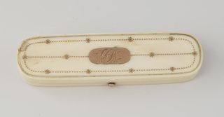 An early 19th century rose gold-inlaid ivory toothpick box. Of rounded oblong form, the hinged cover