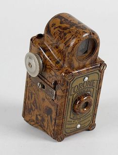 A Coronet Midget, light and dark brown flecked Bakelite miniature camera, manufactured by the Corone
