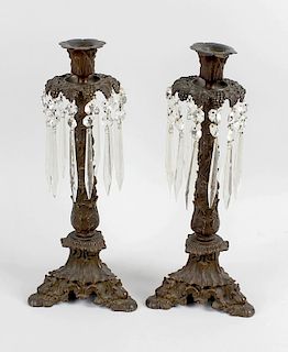A pair of Regency bronze candle lustres, each having formalised leaf socles above the grapevine moul