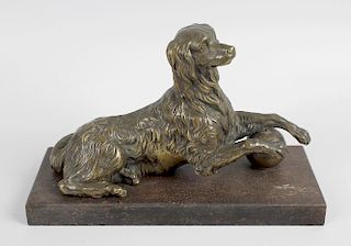 A 19th century French bronze figure, modelled as a spaniel reclining with a ball beneath the front p