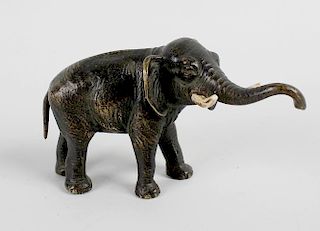 A small Japanese Meiji period bronze figure, modelled as an elephant stood with raised trunk and app