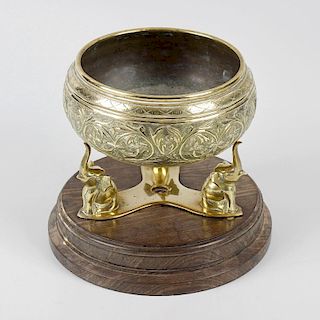 An Indian brass alloy bowl on stand. Of squat circular cauldron form decorated in relief with foliat