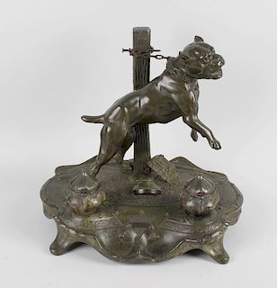 A large spelter inkstand, modelled as a rearing pitbull or similar dog chained to a post, stood upon