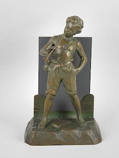 A spelter lamp base, modelled as a male trumpeter stood upon a rectangular base before a mirror plat