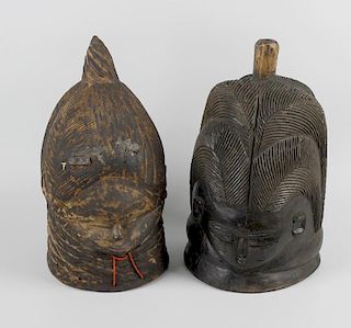 Two wooden Bundu helmet masks. Each modelled as a female head having extended forehead and small fac