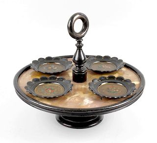 A lacquer and papier mache Lazy Susan, the ring handle and knopped stem leading to the circular tray