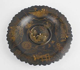 An Oriental black-lacquered papier mache dish or comport. Of multi-lobed circular form decorated wit
