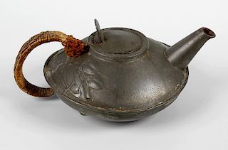 A Liberty & Co Tudric pewter teapot, by Archibald Knox, of squat circular form, having stylised foli