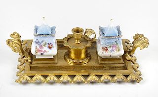 A gilt metal double inkwell, the twin porcelain lidded wells with hand painted floral decoration, se