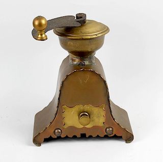 A copper and brass coffee mill, of arched form having scalloped edges and single brass drawer below