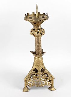 A cast metal pricket candlestick, the castellated top over acanthus collar and cylindrical stem rais