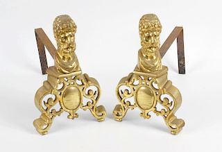A pair of cast brass fire dogs, each having classical male bust over A-frame pierced support, each 1