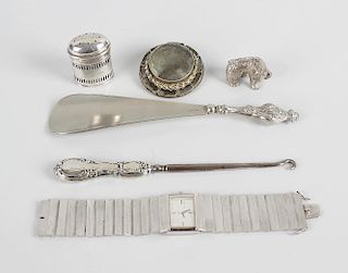 A bag containing various silver and base metal itemsComprising a boot pull, shoe horn, and pepperett