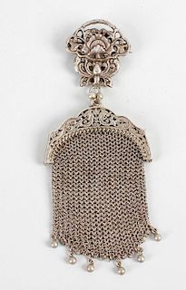 A late 19th century lady's white metal miniature purse, with chain mail bag, and pierced clip decora