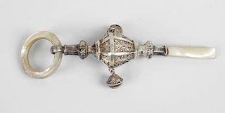 A George V silver child’s rattle, the shaped body with paneled decoration, fitted with two hanging b
