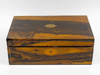 A Victorian brass-inlaid coromandel lap desk or writing box. The hinged brass-strung rectangular cov