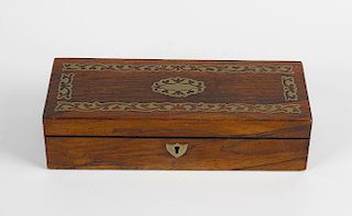 A Regency brass inlaid rosewood glove box, of rectangular form having foliate scrollwork inlaid bord