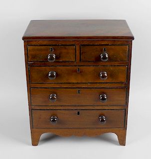 A Regency apprentice miniature mahogany chest of drawers, having rounded edges to the rectangular to