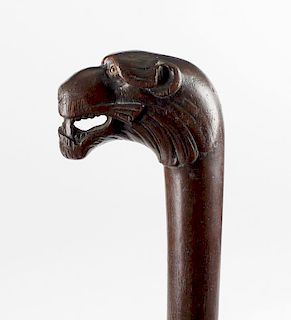 An early 19th century walking stick, having carved wooden lion's head terminal with open mouth and i